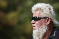 John Daly walk off the first tee during the first round of the PNC Championship golf tournament Saturday, Dec. 18, 2021, in Orlando, Fla. (AP Photo/Scott Audette)