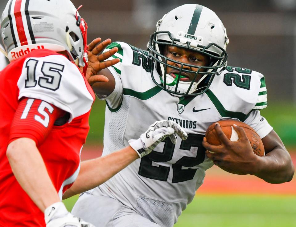 RON JOHNSON/JOURNAL STAR Richwoods running back T'Nahleg Hall stiff arms Morton's Camden Hopkins on this touchdown run in the fourth quarter of Saturday's Class 5A playoff game.