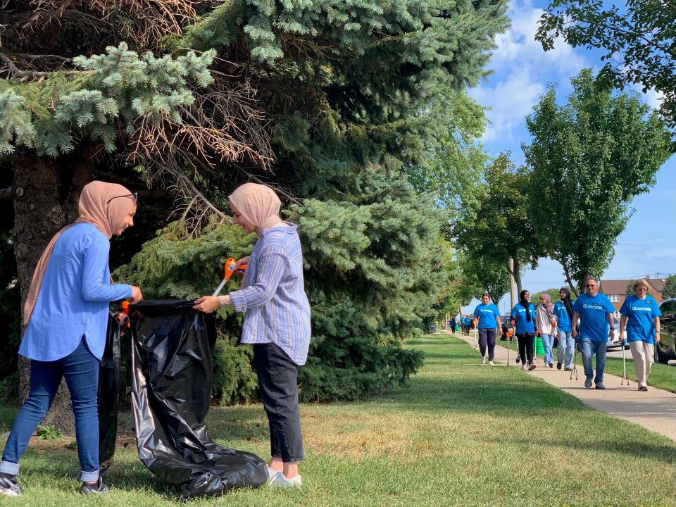 Lena Abukhamireh, left, and Leya Rizeq pick up trash during the second annual Interfaith Neighborhood Clean-up, organized by the Church of Jesus Christ of Latter-day Saints and the Islamic Society of Milwaukee, on Saturday, Sept. 10, 2022, near South 13th Street and Layton Avenue. Abukhamireh and Rizeq are recent graduates of Marquette University, where they were leaders of the organization Students for Justice in Palestine.