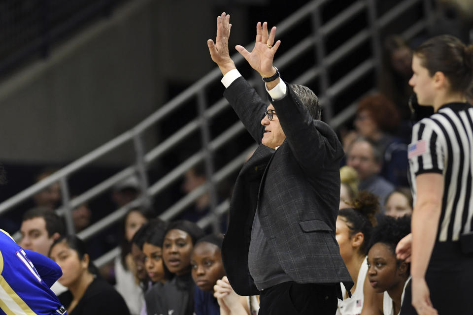 Connecticut head coach Geno Auriemma gets his team's attention during the second half of an NCAA college basketball game against Tulsa, Sunday, Jan. 19, 2020, in Storrs, Conn. (AP Photo/Stephen Dunn)