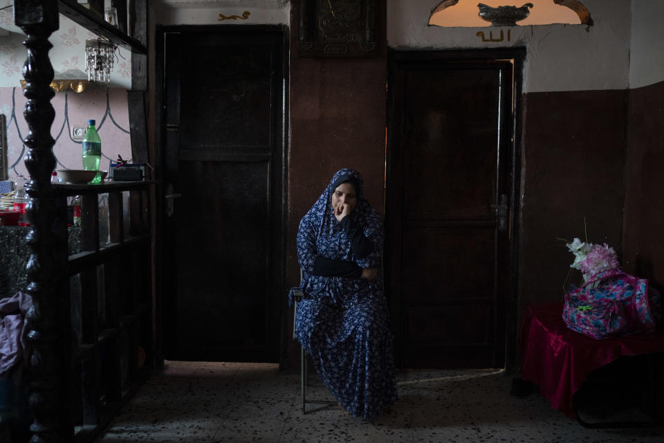 In this Sept. 12, 2018, photo, Amani al-Bilbisi, sits outside her son Mohammed Khader's room as he lays in bed in Gaza City. Mohammed was shot in the leg at one of the demonstrations on Gaza strip's border with Israel. Ever since Hamas launched demonstrations in March against Israel's blockade of Gaza, children have been a constant presence in the crowds. Since then, U.N. figures show that 948 children under 18 have been shot by Israeli forces and 2,295 have been hospitalized, including 17 who have had a limb amputated. (AP Photo/Felipe Dana)