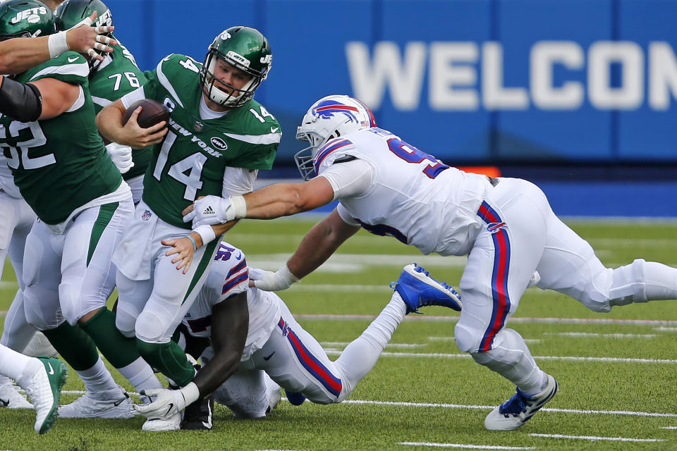 New York Jets quarterback Sam Darnold (14) is sacked by Buffalo Bills defensive end Mario Addison (97), center rear, and Harrison Phillips, right, during the second half of an NFL football game in Orchard Park, N.Y., Sunday, Sept. 13, 2020. (AP Photo/Jeffrey T. Barnes)