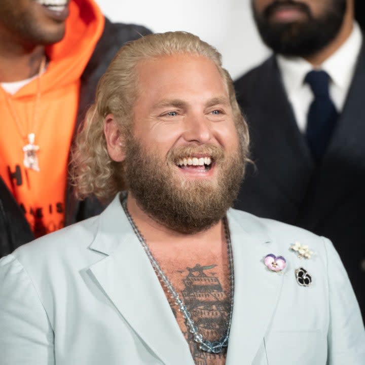 Jonah Hill smiles at a red carpet film premiere