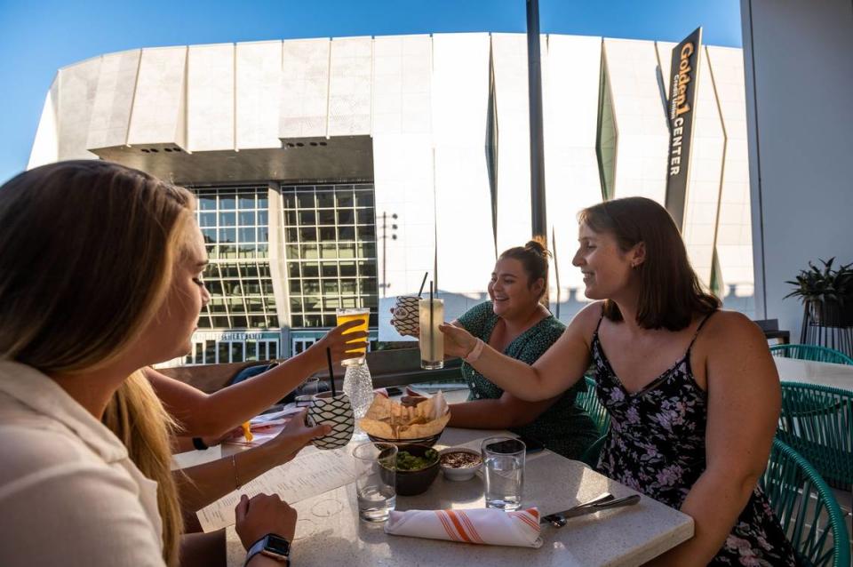 We just went wedding dress shopping, said recently-engaged Hailey Wright, right, of Sacramento, while sitting with her friends on a patio at Polanco across from Golden 1 Center at DoCo on Thursday, July 22, 2021, in downtown Sacramento. She was toasting with her friends, sitting counter-clockwise: Megan Williams, who now lives in Woodland; Rita Dawson, visiting from San Antonio, Texas; and Haley Cameron, who is also living in Sacramento. I go all the time, Wright said about attending Sacramento Kings games. I live really close, so I usually just walk here with my fiancé.