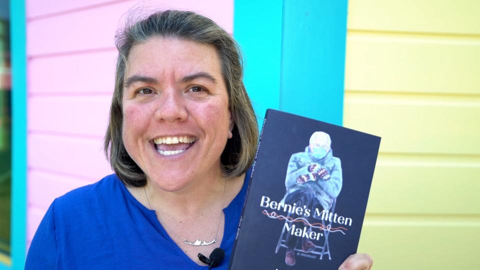 Essex Junction resident Jen Ellis holds up a copy of her new memoir "Bernie's Mitten Maker."