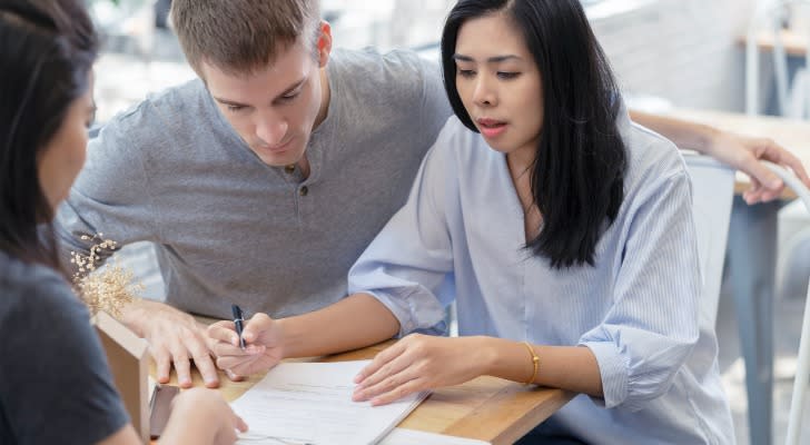 A couple reviewing the value of their  personal property with an insurance agent.