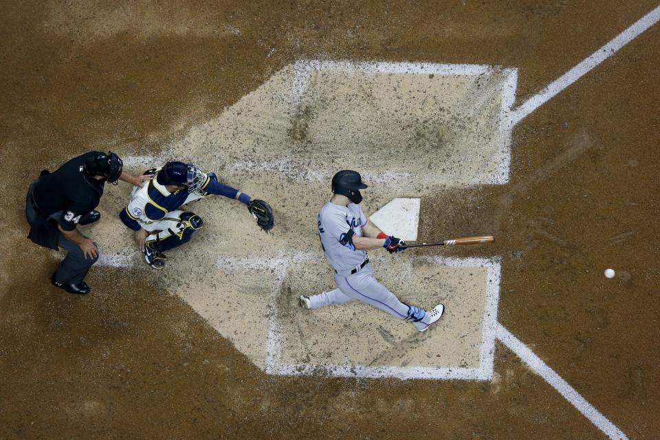 Miami Marlins' Corey Dickerson hits an RBI single during the sixth inning of a baseball game against the Milwaukee Brewers Monday, April 26, 2021, in Milwaukee. (AP Photo/Morry Gash)