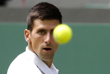 Novak Djokovic of Serbia in action during his match against Philipp Kohlschreiber of Germany at the Wimbledon Tennis Championships in London, June 29, 2015. REUTERS/Suzanne Plunkett