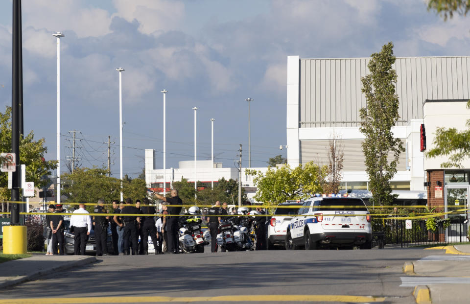 Police officers gather at the scene of a shooting in Mississauga, Ontario, Monday, Sept. 12, 2022. (Arlyn McAdorey/The Canadian Press via AP)