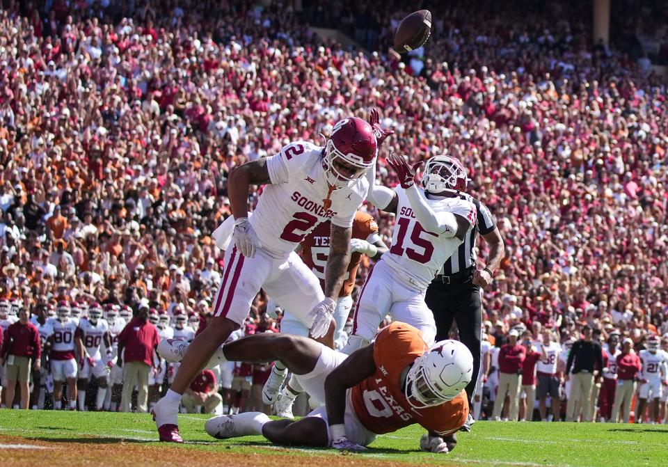 Oklahoma defensive back Kendel Dolby pulls in an interception after the ball was jarred loose from Texas tight end Ja'Tavion Sanders in the first quarter Saturday at the Cotton Bowl. Sanders, nursing a sore ankle, played a secondary role to backup Gunnar Helm in the game.