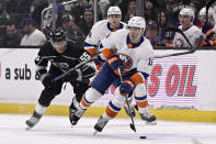 New York Islanders left wing Pierre Engvall (18) takes the puck upice with Los Angeles Kings right wing Quinton Byfield (55) in pursuit during the first period of an NHL hockey game in Los Angeles, Monday, March 11, 2024. (AP Photo/Alex Gallardo)