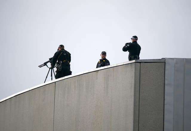 Police marksmen set up on the roof of the Scottish Parliament Building in Edinburgh ahead of the procession