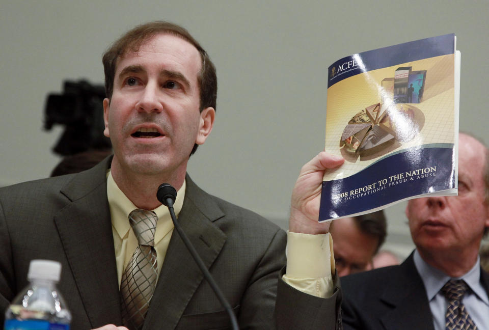 WASHINGTON - FEBRUARY 04:  Harry Markopolos hold up a book while testifying during a House Financial Services Committee hearing on Capitol Hill February 4, 2009 in Washington, DC. The committee is hearing testimony on the alleged $50 billion dollar Madoff ponzi scheme and regulatory failures.  (Photo by Mark Wilson/Getty Images)