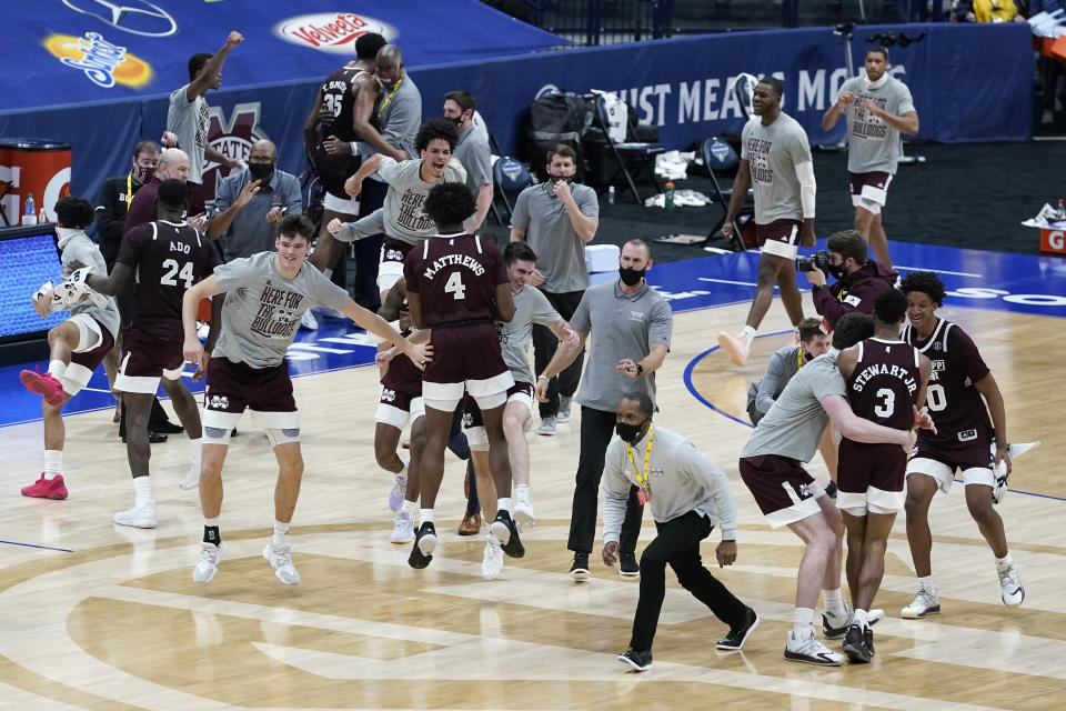 Mississippi State players and coaches celebrate after beating Kentucky in an NCAA college basketball game in the Southeastern Conference Tournament Thursday, March 11, 2021, in Nashville, Tenn. (AP Photo/Mark Humphrey)