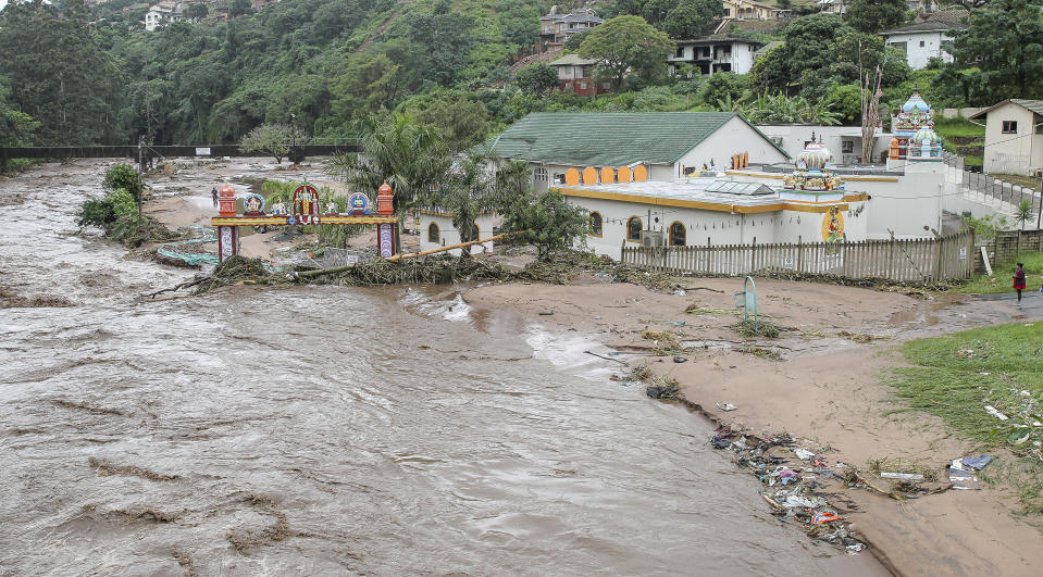 Floodwaters wash through a property near Durban, South Africa, Tuesday, April 23, 2019. South African media report Tuesday that at least 33 people are dead from flooding and mudslides in the country's eastern KwaZulu-Natal province caused by heavy rains that began on Monday. (AP Photo)