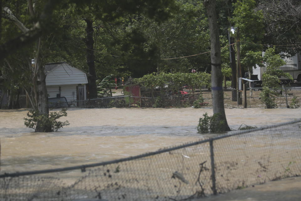 A mobile home in an unincorporated area in east Harris County near Houston on Sunday morning, May 5, 2024, is surrounded by flood waters caused by the nearby San Jacinto River, which overflowed due to heavy rainfall earlier this week. (AP Photo/Lekan Oyekanmi)