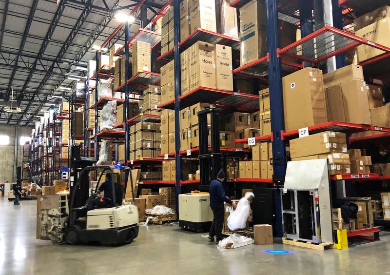FILE PHOTO: Warehouse workers deal with inventory stacked up to the ceiling at an ABT Electronics Facility in Glenview