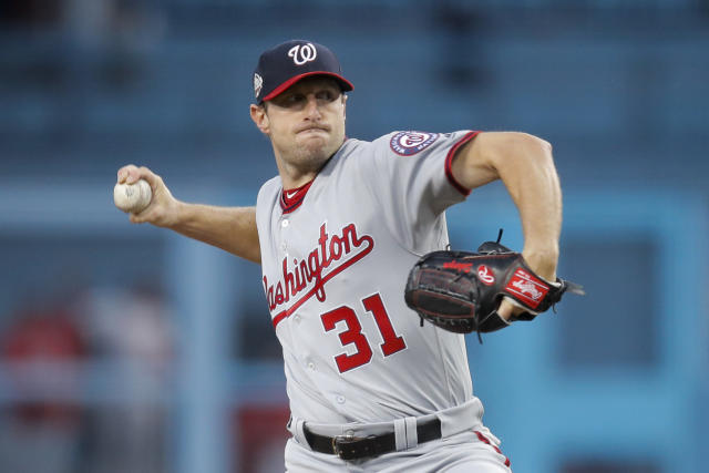 Washington Nationals starting pitcher Max Scherzer, left, stands