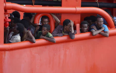 Migrants wait to disembark from a merchant ship in the Sicilian harbour of Pozzallo, Italy August 2, 2015. REUTERS/Antonio Parrinello