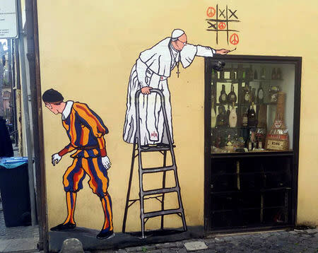 A graffiti depicting Pope Francis and a Swiss guard is seen in Borgo Pio, in Rome, Italy, October 19, 2016. REUTERS/Stringer