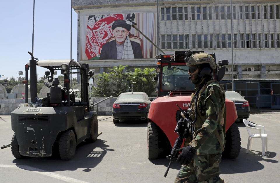 A Taliban soldier patrols at Hamid Karzai International Airport in Kabul, Afghanistan, Sunday, Sept. 5, 2021. Some domestic flights have resumed at Kabul's airport, with the state-run Ariana Afghan Airlines operating flights to three provinces. (AP Photo/Wali Sabawoon)