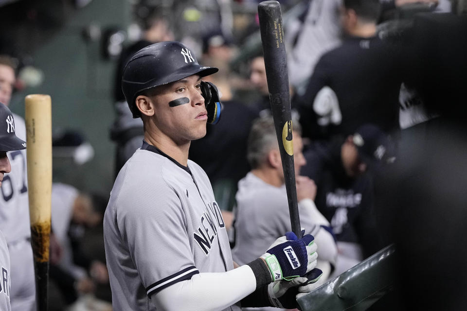 New York Yankees Aaron Judge stands in the dugout ahead of Game 1 of baseball's American League Championship Series between the Houston Astros and the New York Yankees, Wednesday, Oct. 19, 2022, in Houston. (AP Photo/Kevin M. Cox)