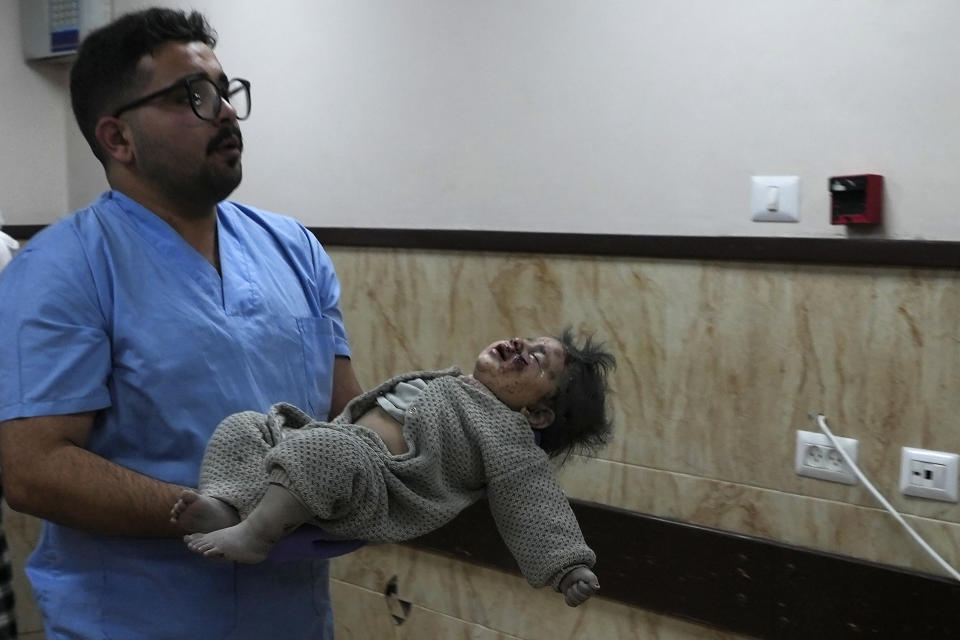 Palestinians wounded in the Israeli bombardment of the Gaza Strip are brought to the hospital in Deir al Balah, Gaza Strip, on Saturday, Dec. 23, 2023. (AP Photo/Adel Hana)