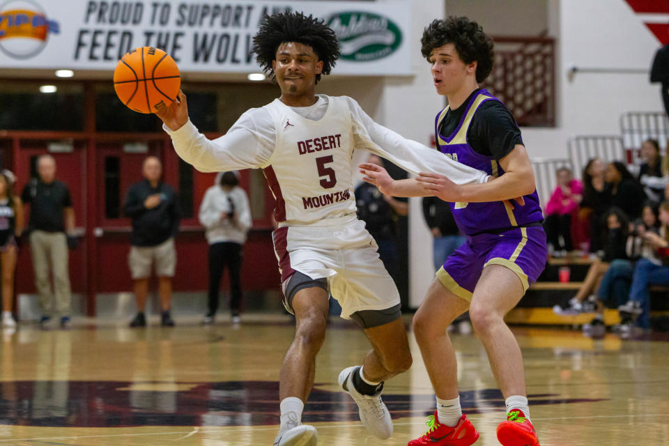 Kalek House (5) passes the ball as Brody Postorino (10) tries to block at Desert Mountain High School gym in Scottsdale on Jan. 24, 2024.