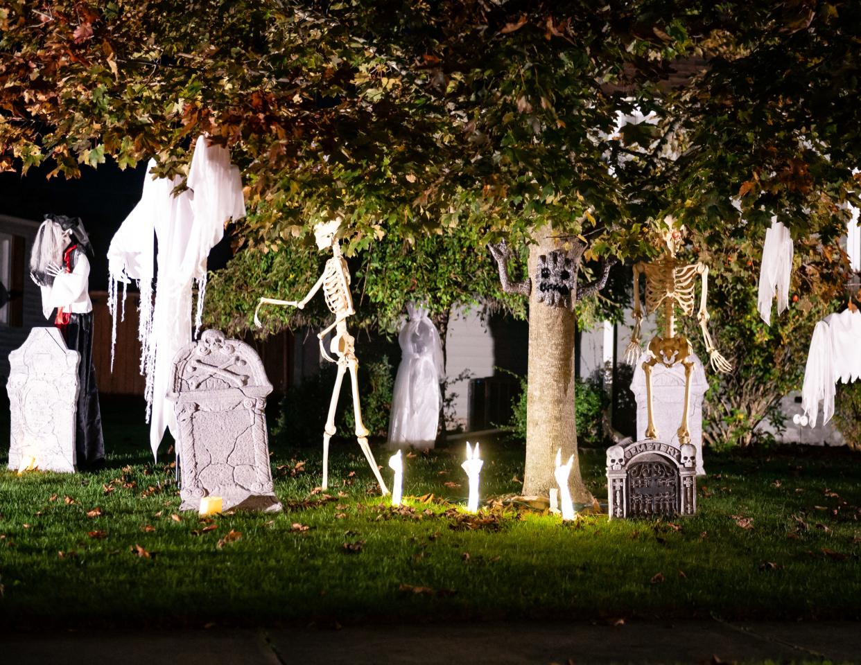 Ghosts and skeletons are spread out in a yard in Utica on Wednesday, October 18, 2023.