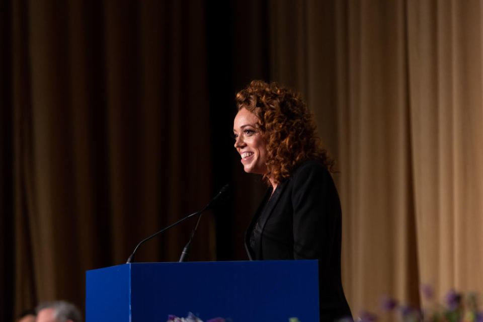 Michelle telling a joke at a podium