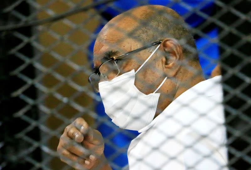 FILE PHOTO: Sudan's ousted President Omar al-Bashir is seen inside the defendant's cage during his and some of his former allies trial over the 1989 military coup that brought the autocrat to power in 1989, at a courthouse in Khartoum