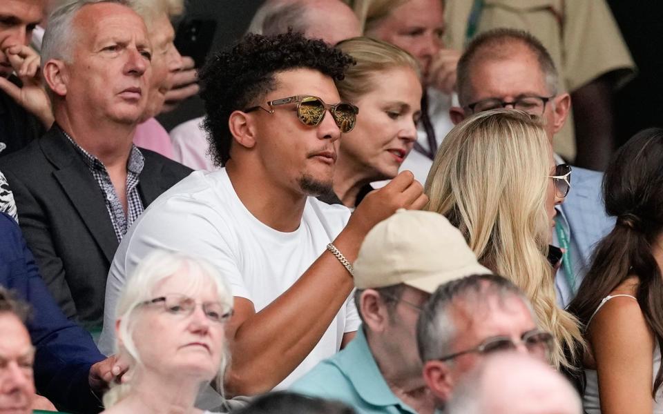 Patrick Mahomes and his wife Brittany, right, watch the third round match between Spain's Carlos Alcaraz and Francis Tiafoe of the United States on Centre Court at the Wimbledon tennis championships in London, Friday, July 5, 2024