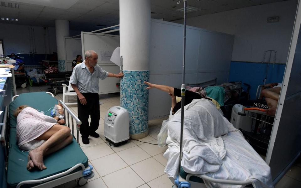 Tunisian Covid-19 patients receive aid at the Charles Nicole hospital's emergency room in the capital Tunis - FETHI BELAID / AFP