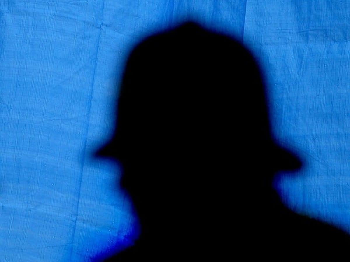 A silhouette of a police officer at a crime scene in London, 2003 (Getty Images)