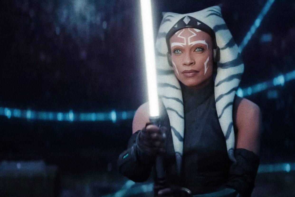 Rosario Dawson as Ahsoka holding a lightsaber.