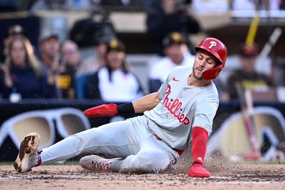 Trea Turner slides to score a run against the Padres.