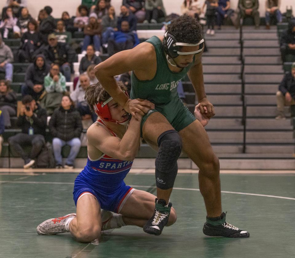 Ocean's Steven Perez (left) defeated Mikel Rodriguez 7-4 in the 126-pound bout in the Spartans' 45-24 win over Long Branch Wednesday night.