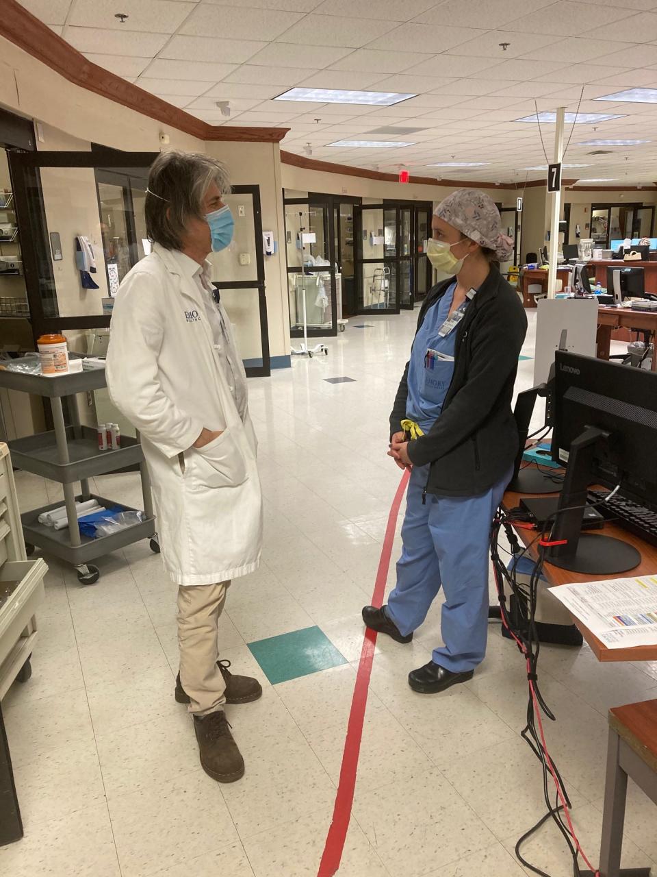 Joel Zivot, an Emory University professor and ICU doctor, speaks with Hailey Wetta, a critical care physician. Both work with COVID-19 patients at Atlanta's Emory Decatur Hospital.