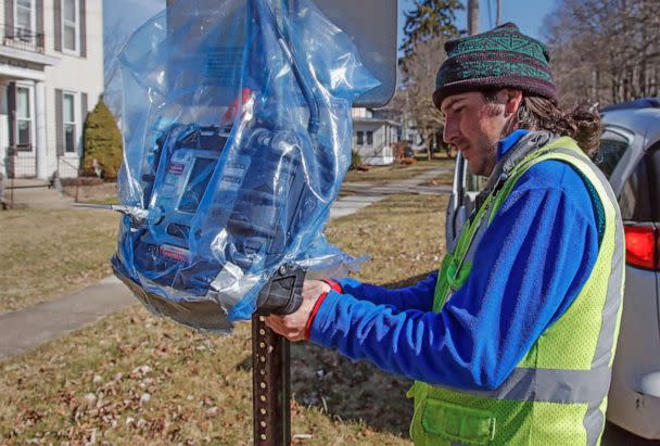 PHOTO: An Environmental Protection Agency employee checks on an air quality monitor as cleanup continues in the aftermath of a Norfolk Southern freight train derailment in East Palestine, Ohio, Feb. 18, 2023. (Tannen Maury/EPA via Shutterstock)