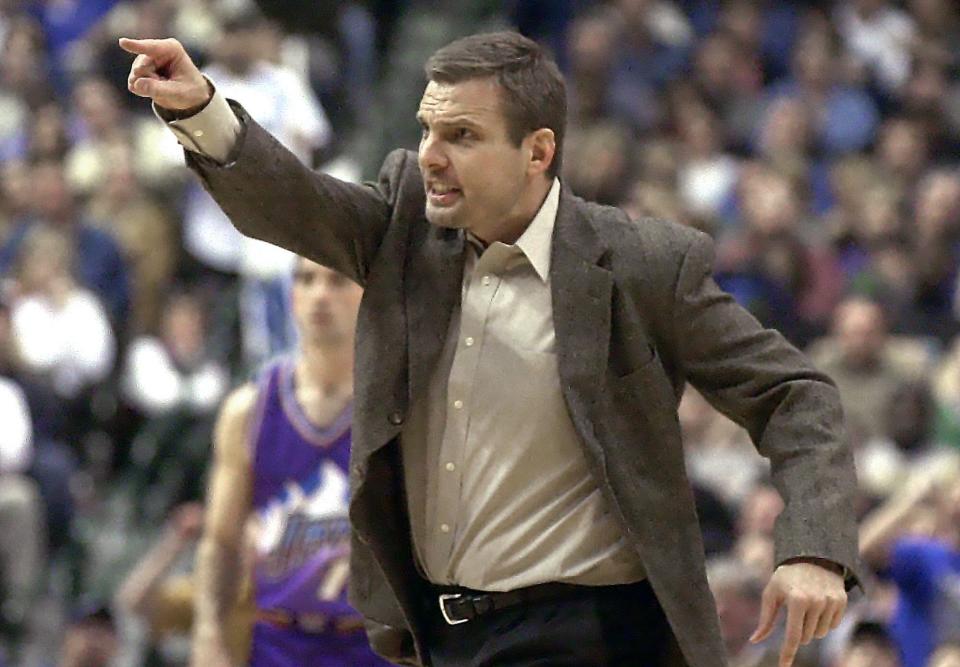 FILE - Dallas Mavericks assistant coach Donnie Nelson gestures during the fourth quarter of an NBA basketball game against the Utah Jazz in Dallas, in this Friday, Dec. 20, 2002, file photo. Mavericks general manager Donnie Nelson, instrumental in the club's acquisitions of Dirk Nowitzki and Luka Doncic, is leaving the organization after 24 seasons. The Mavericks said Wednesday, June 16, 2021, the club and Nelson agreed to part ways, with owner Mark Cuban saying the son of former coach Don Nelson was “instrumental to our success and helped bring a championship to Dallas.”(AP Photo/LM Otero, File)
