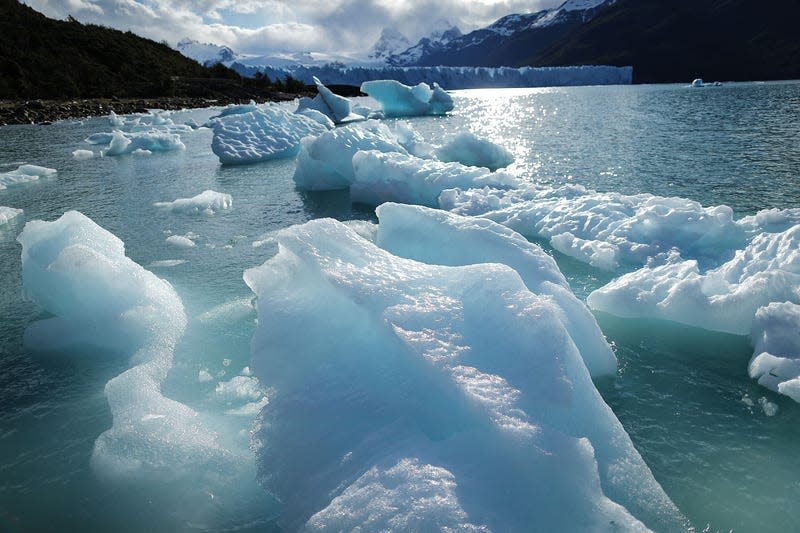 Melted glacial ice floats in front of the Perito Moreno glacier in Los Glaciares National Park, Patagonia