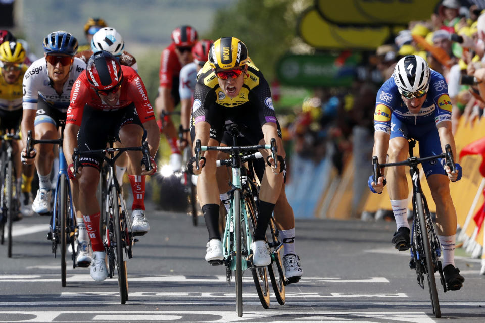 Belgium's Wout Van Aert, center, sprints to win the tenth stage of the Tour de France cycling race over 217 kilometers (135 miles) with start in Saint-Flour and finish in Albi, France, Monday, July 15, 2019. (AP Photo/ Thibault Camus)