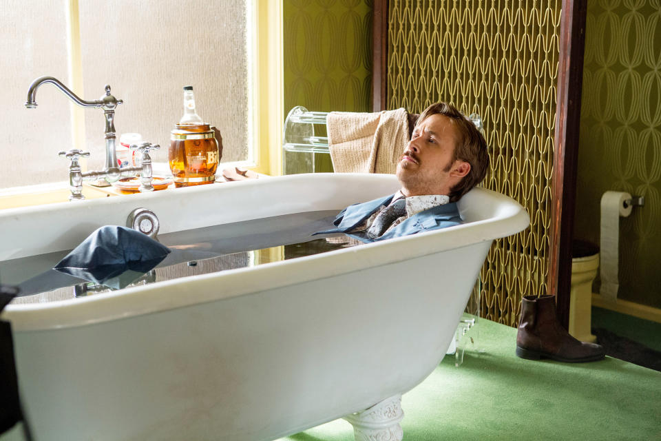 Ryan Gosling wearing a suit, sitting in a bathtub