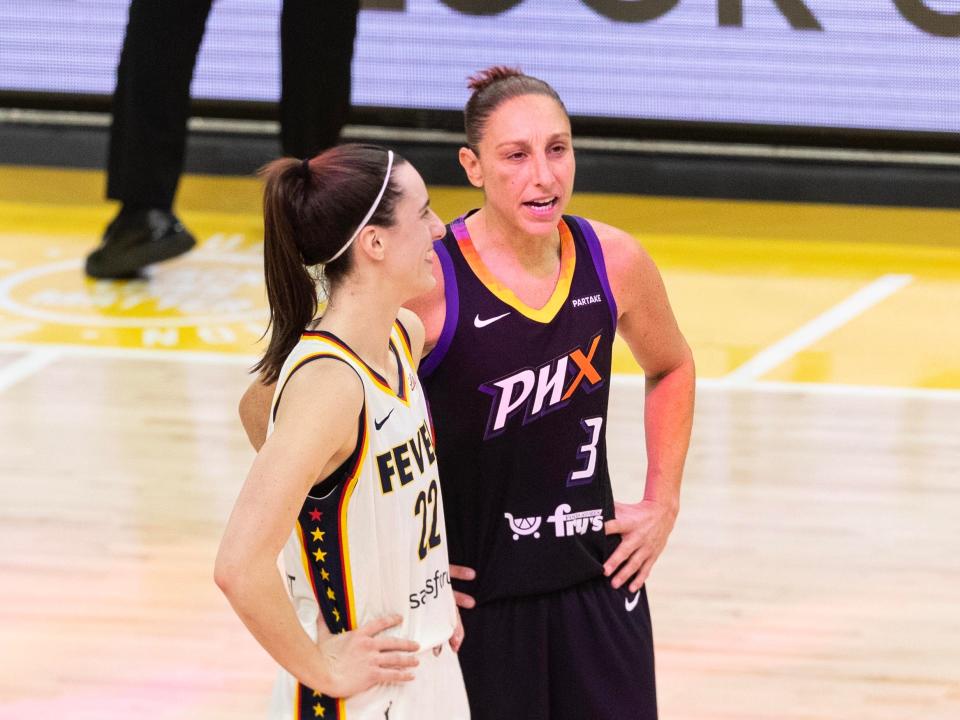 Indiana Fever guard Caitlin Clark (22) and Phoenix Mercury guard Diana Taurasi (3) talk at half court during a free throw on June 30, 2024, at Footprint Center in Phoenix.