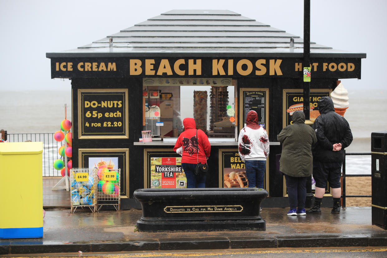 People take a walk along the windy seafront at Scarborough, North Yorkshire. Picture date: Saturday August 29, 2020. Forecasters predict this Bank Holiday Monday could be the coldest on record for some parts of the UK as temperatures are expected to be well below average for the time of year. See PA story WEATHER Thunderstorms. Photo credit should read: Danny Lawson/PA Wire (Photo by Danny Lawson/PA Images via Getty Images)