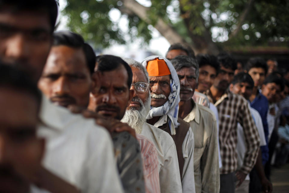 Indians stand in a queue to cast their votes in Shahbazpur Dor village in Amroha, in the northern Indian state of Uttar Pradesh, Thursday, April 17, 2014. Indians cast ballots Thursday on the biggest day of voting in the country's weekslong general election, streaming into polling stations even in areas where rebels threatened violence over the plight of India's marginalized and poor. (AP Photo/Altaf Qadri)