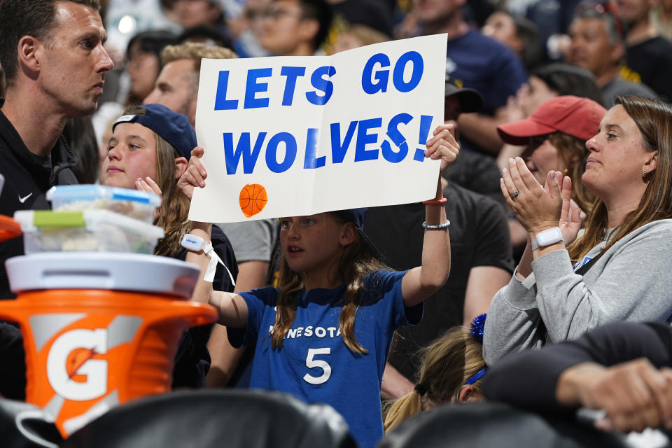 A Minnesota Timberwolves fan holds up a sign in the second half of Game 1 of an NBA basketball second-round playoff series against the Denver Nuggets, Saturday, May 4, 2024, in Denver. (AP Photo/David Zalubowski)