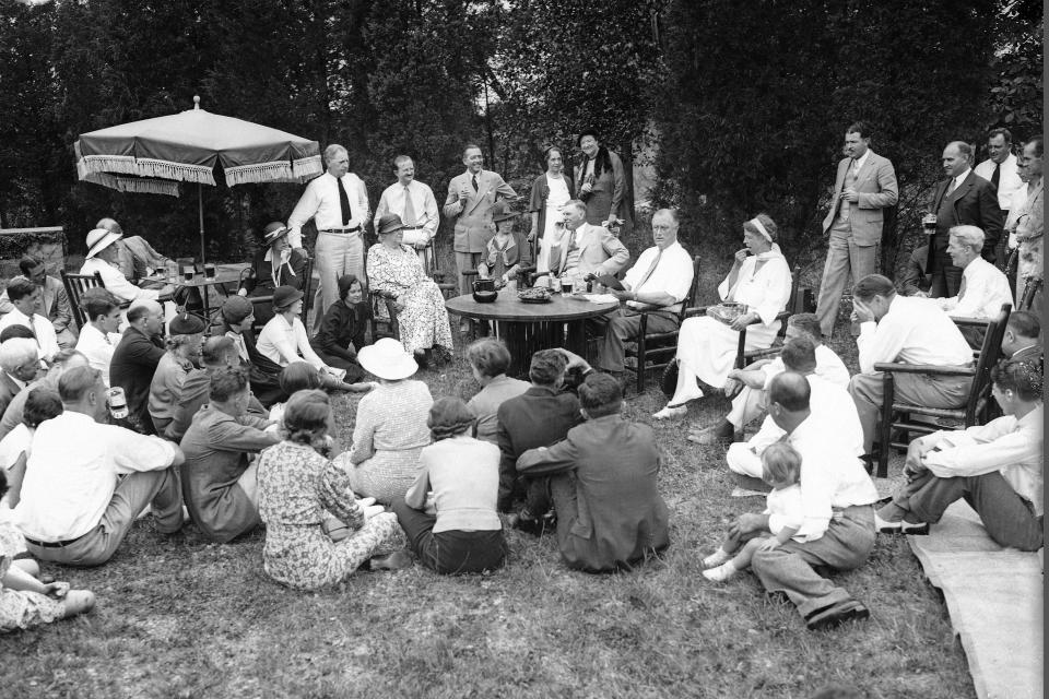 File - President Franklin Roosevelt reads to his guests as he and first lady Eleanor Roosevelt, at table, host a Labor Day picnic at their residence in Hyde Park, N.Y., Sept. 3, 1934. Labor Day, 2023, is right around the corner. And while many may associate the holiday with major retail sales and end-of summer barbecues, Labor Day's roots in worker-driven organizing feel especially significant this year. (AP Photo, File)