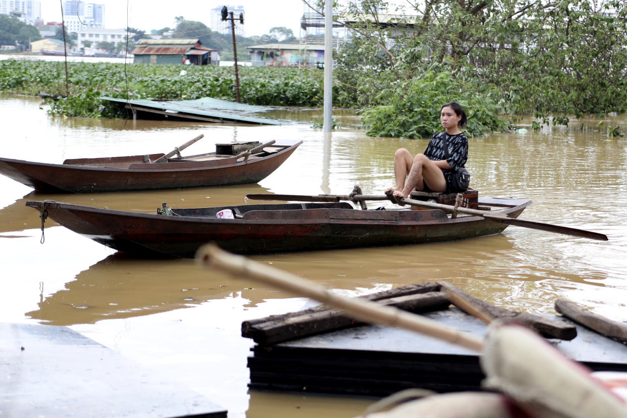 A woman paddles a boat on a flooded street, following Typhoon Yagi in Hanoi, Vietnam on Tuesday, Sept. 10, 2024. (AP Photo/Huy Han)