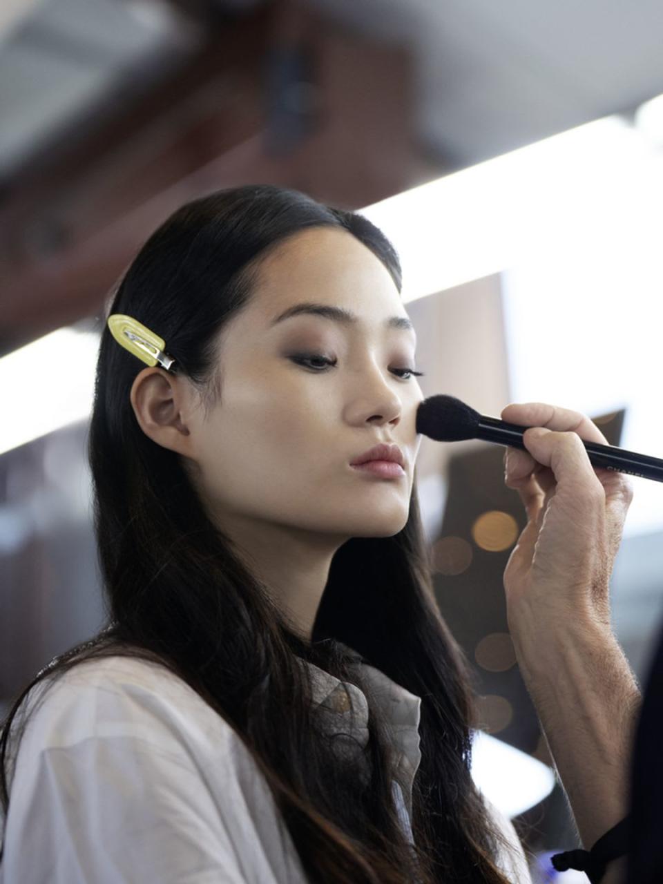 Chanel model having blush applied to her cheeks 